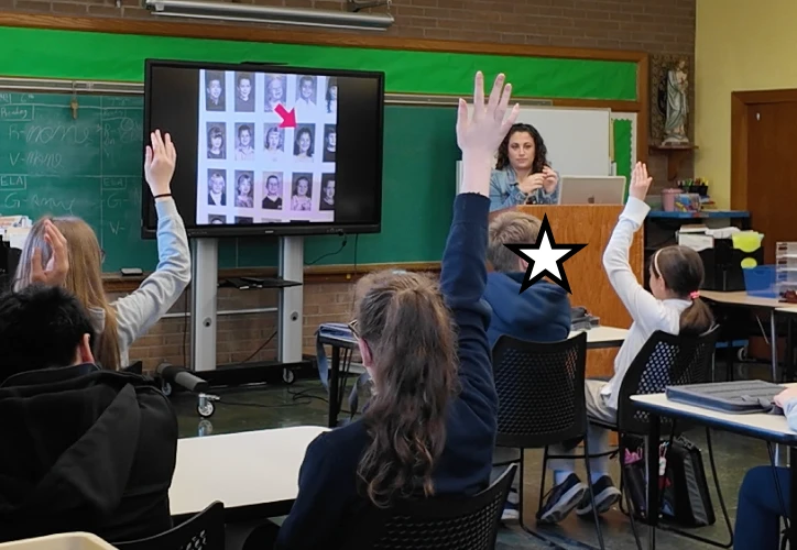 Students raising hands during Chelsea's classroom visit